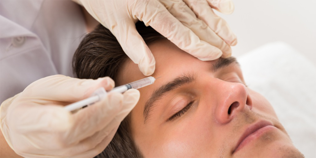A man getting botox or fillers on the forehead