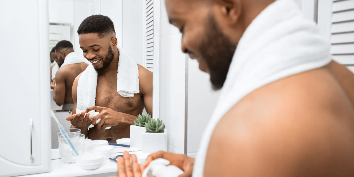 Man applying shaving cream to his hand in the bathroom before shaving