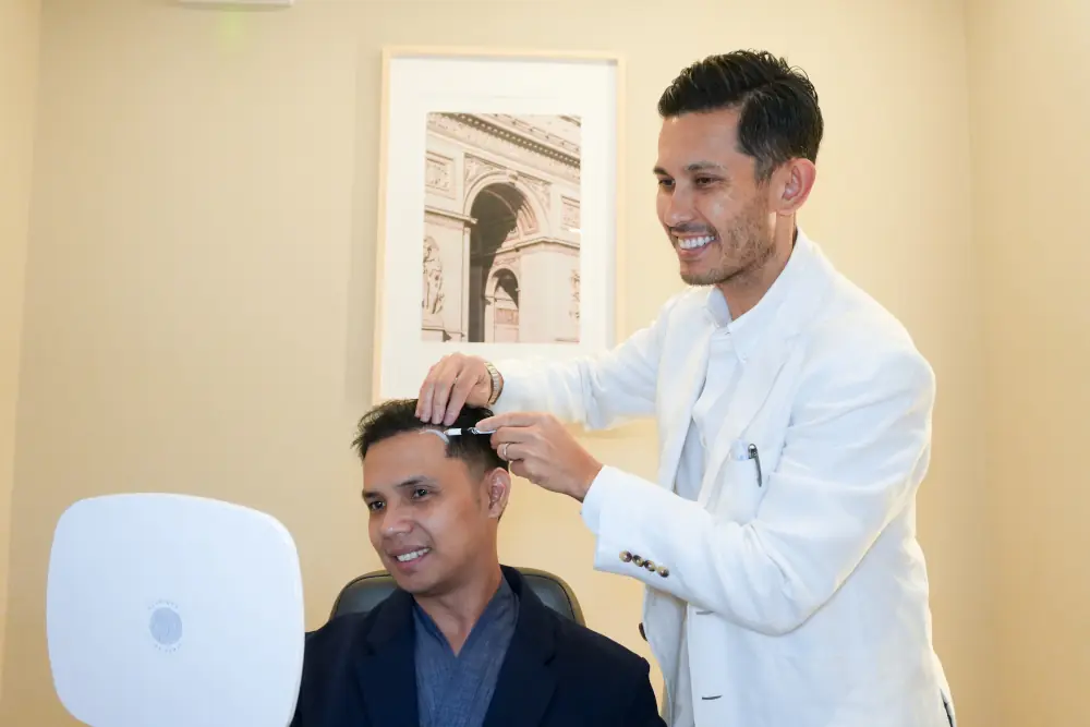 Doctor examining patient's hairline